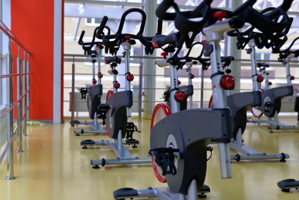 Multiple exercise bicycles inside a gym.