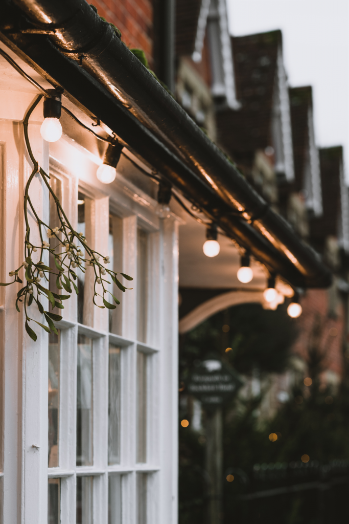 Storefront with white paned windows with twinkle lights