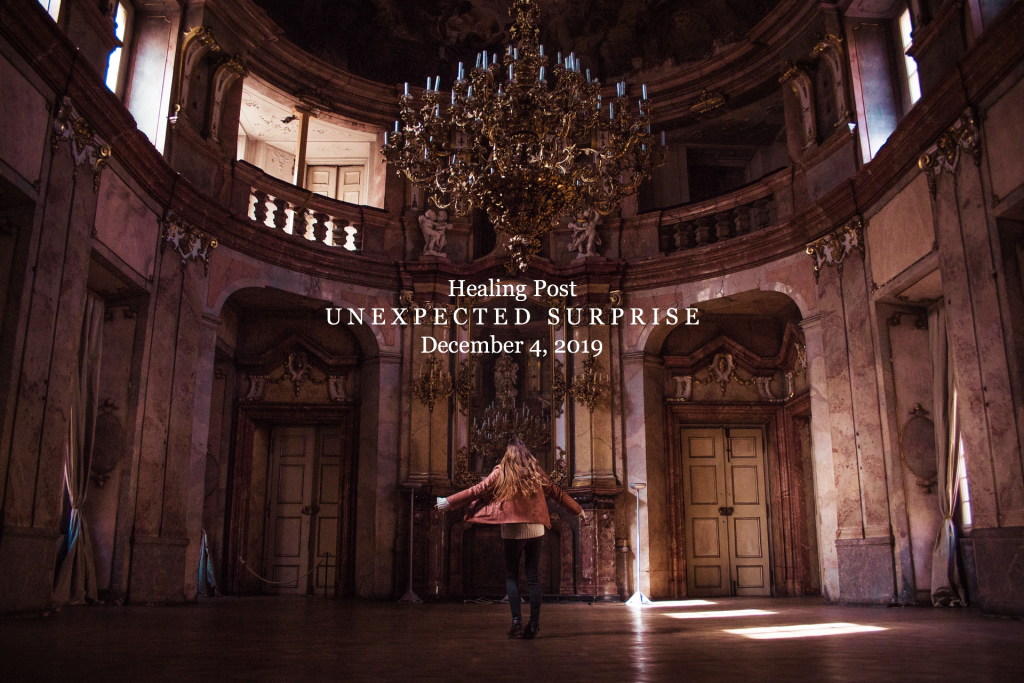 Woman dancing in ballroom with chandelier