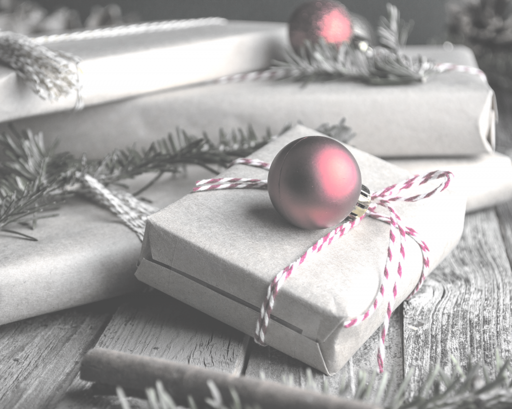 Close up of wrapped packages with red ornaments