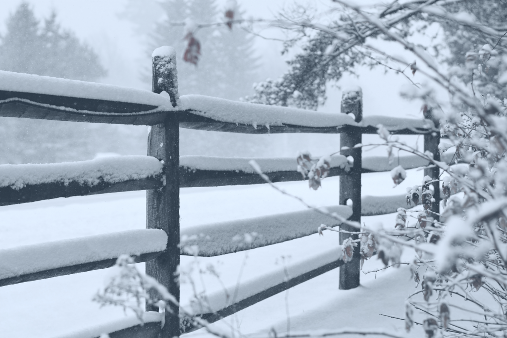 Wood fence in the winter time with snow 