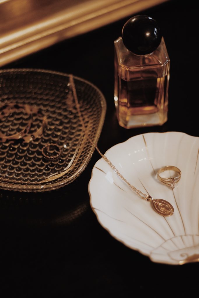 Close up image of gold jewelry and perfume.