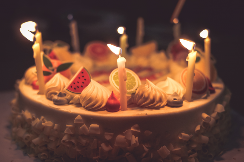 Close up image of birthday cake with lit candles
