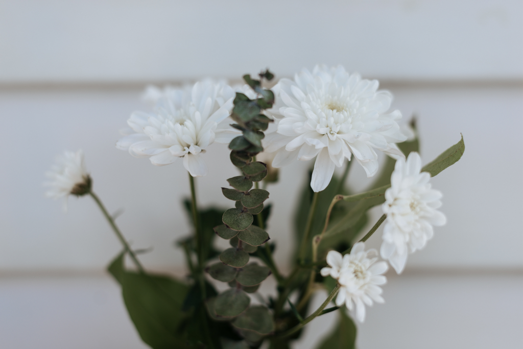 Close up image of white flower bouquet against white background