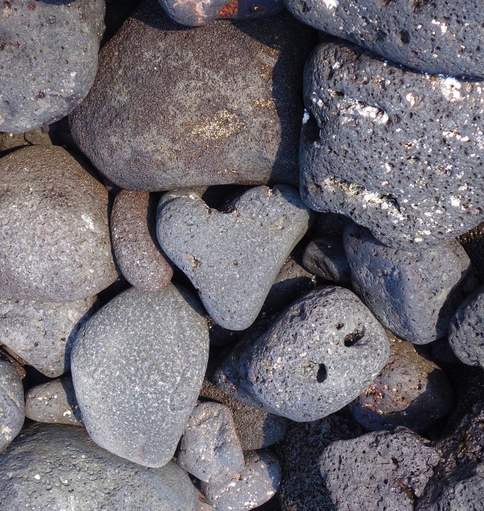 Close up image of beach rocks with one heart shaped beach rock