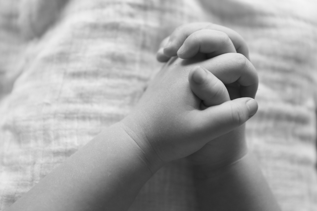 Toddler's hands held in prayer