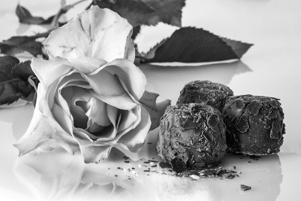 Black and white image of rose and chocolate truffles